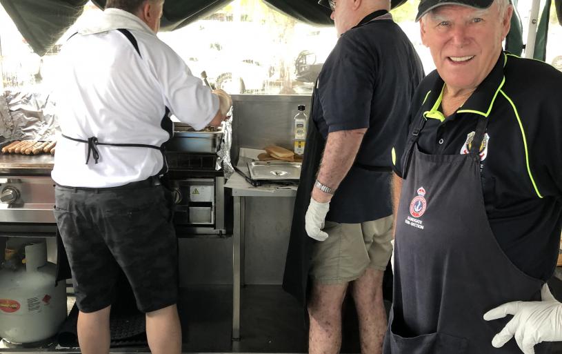 The Sub-Section's fundraising sausage sizzle crew in action on 23 April 2019 outside Carseldine Bunnings. Pictured is Sub-Section Vice-President, Allan Bird (front right), Peter Collins (left rear) and Alex Tweedie.